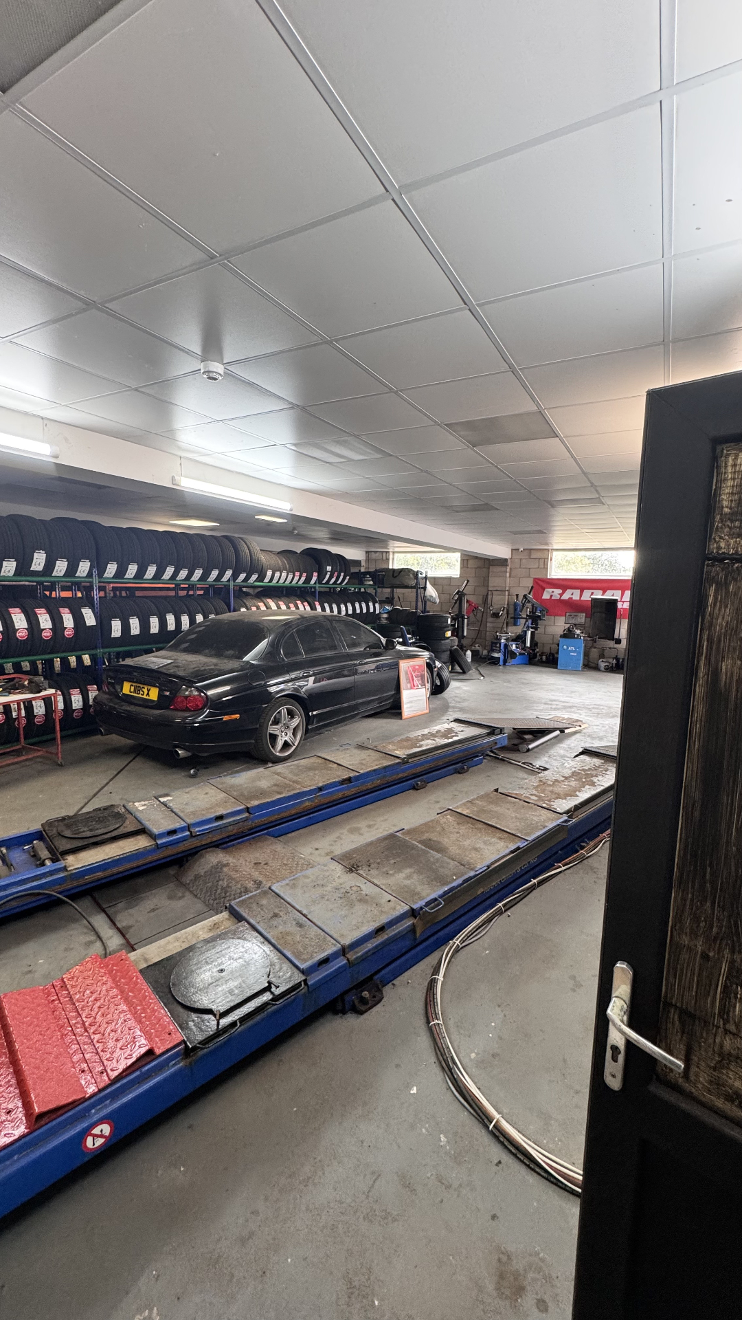 Alignment ramps and tyre stock inside our Beoley workshop near Redditch